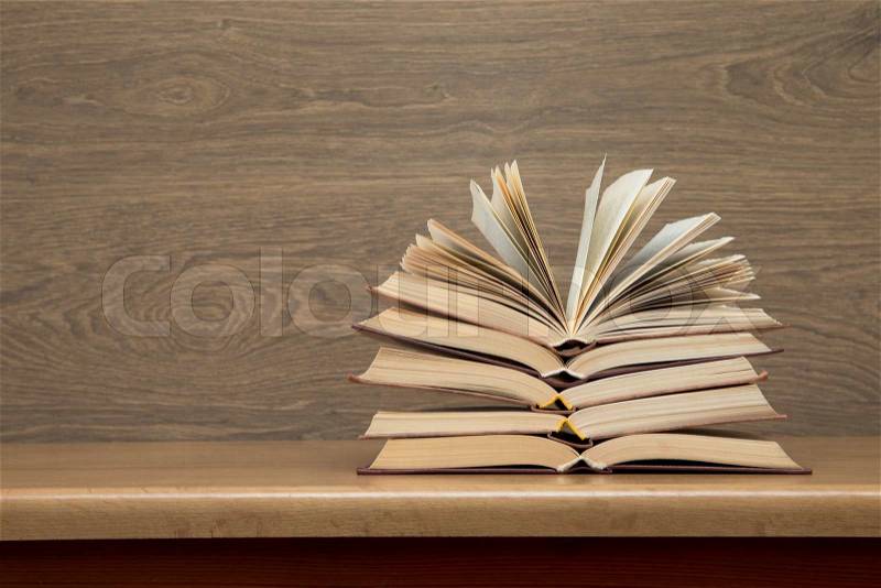 Books on wooden deck tabletop, stock photo