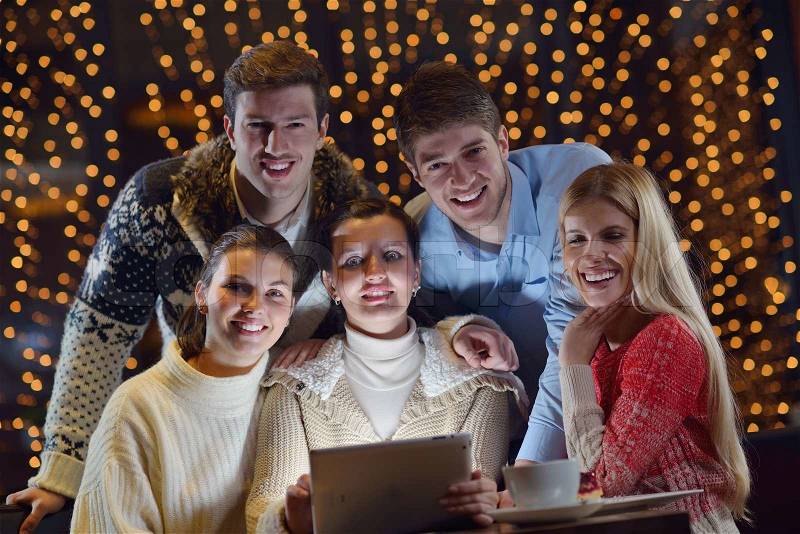 Group of happy people looking at a tablet computer, stock photo