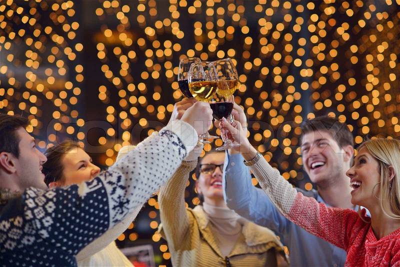 Group of happy young people drink wine at party disco restaurant, stock photo