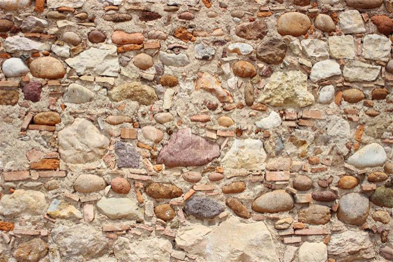 Unstructered wall with rocks tiles and cement, stock photo