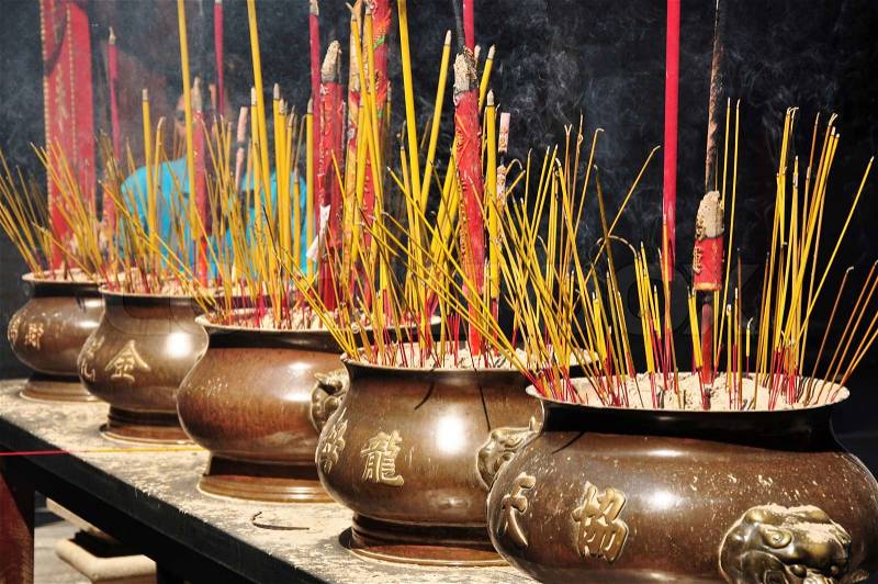 Red incense or joss sticks for buddhist prayers in Vietnam , stock photo