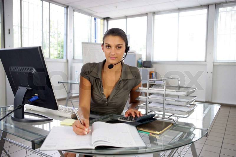 A receptionist busy at work, stock photo
