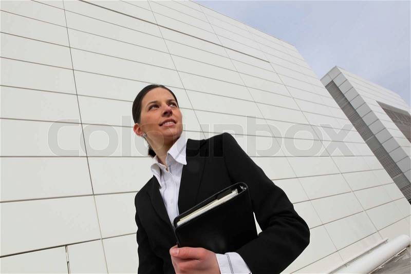 Woman carrying a personal organizer, stock photo