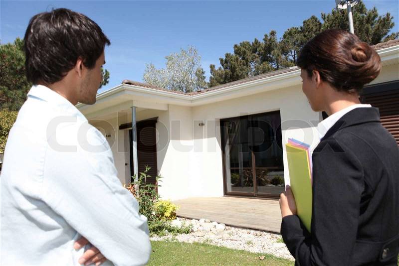 Estate agent about to show customer around property, stock photo