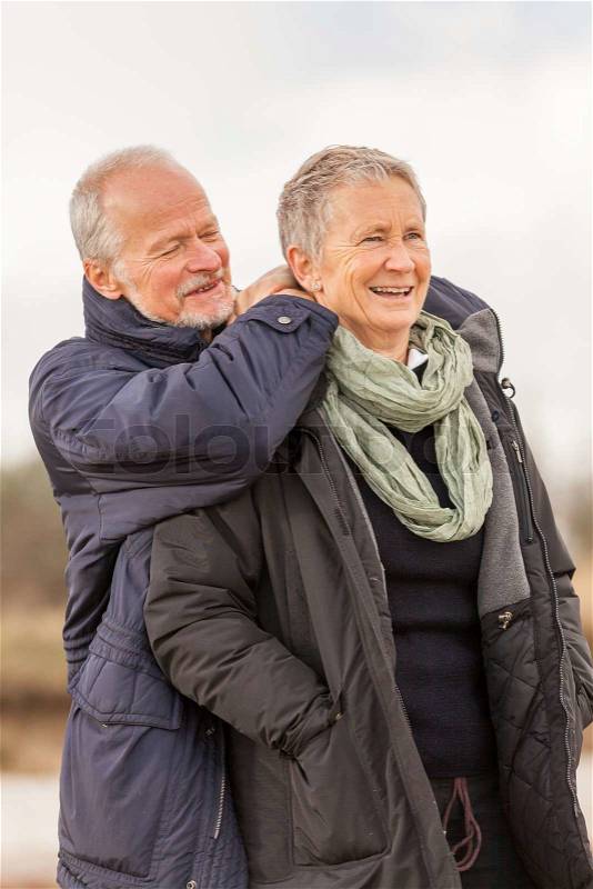 Happy senior couple elderly people together outdoor in autumn winter, stock photo