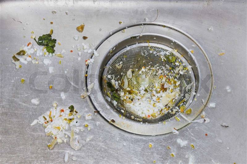 Close up dirty sink or basin with foodwaste after wash dishware, stock photo