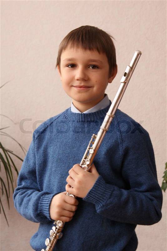 Boy playing the flute, stock photo
