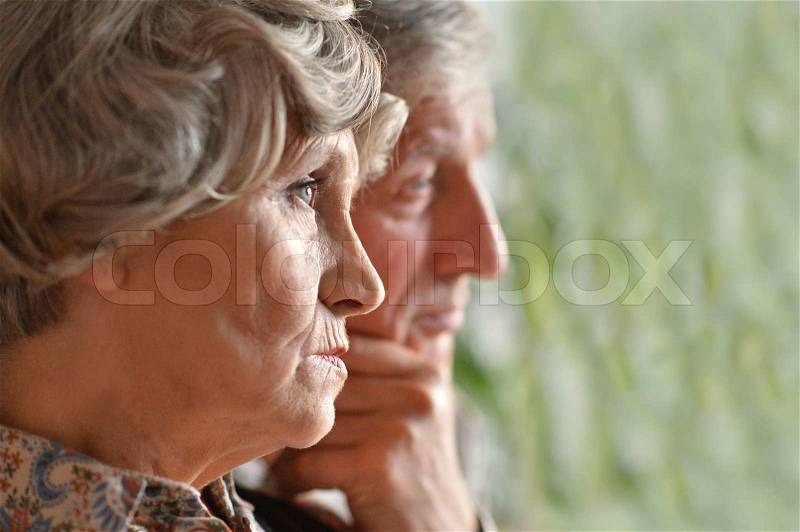 Close-up portrait of an elder couple at home, stock photo