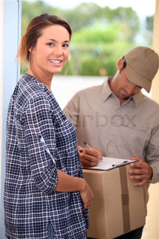 Woman receiving package, stock photo