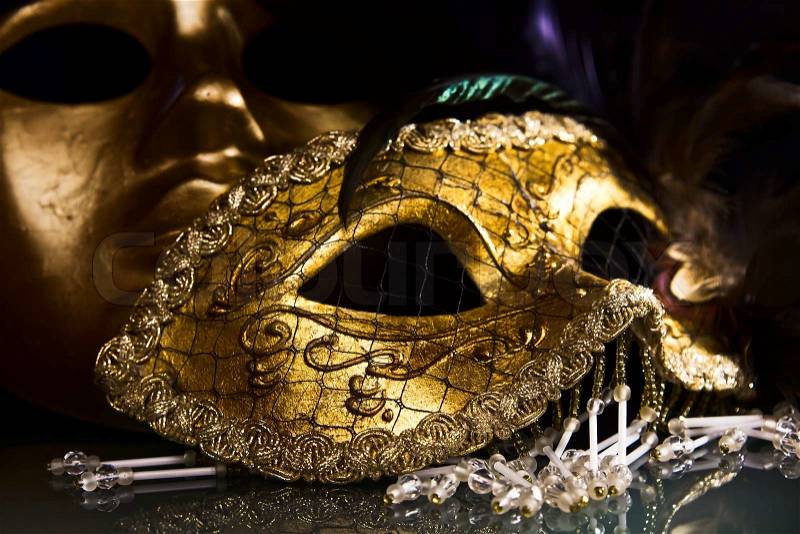 Old gold Venetian masks on a glass table, stock photo