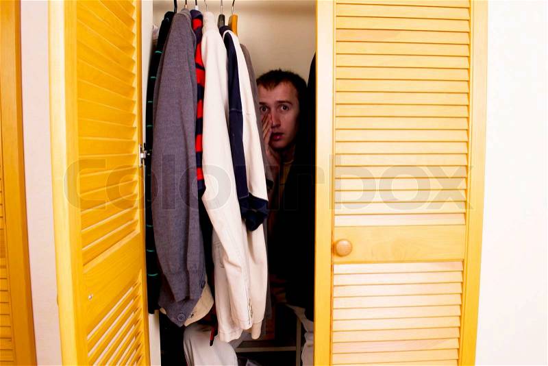 A Man Hiding in the Closet, stock photo