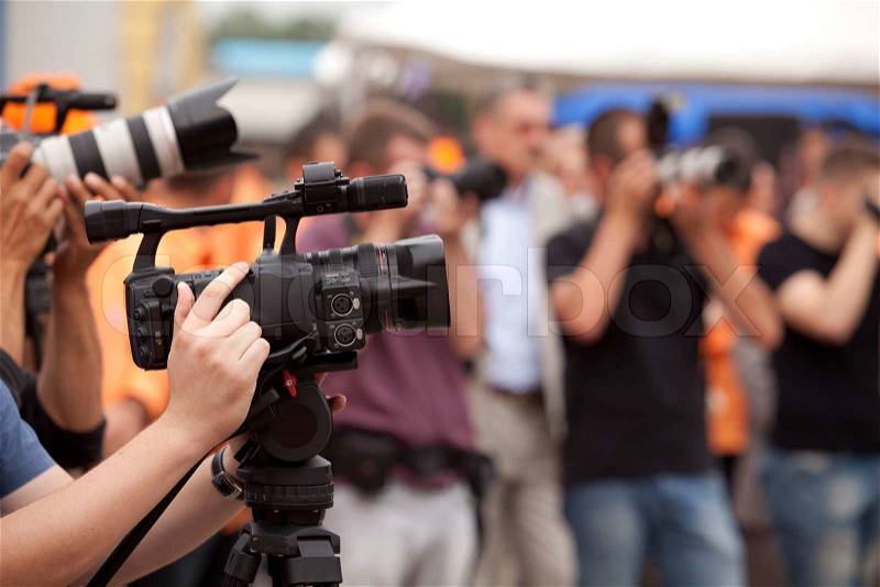 Covering an event with a video camera, stock photo