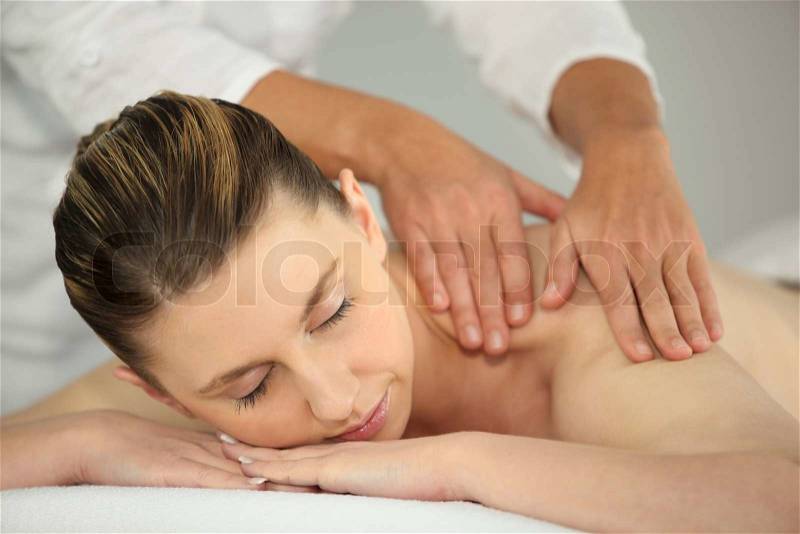 Woman having a back massage, stock photo