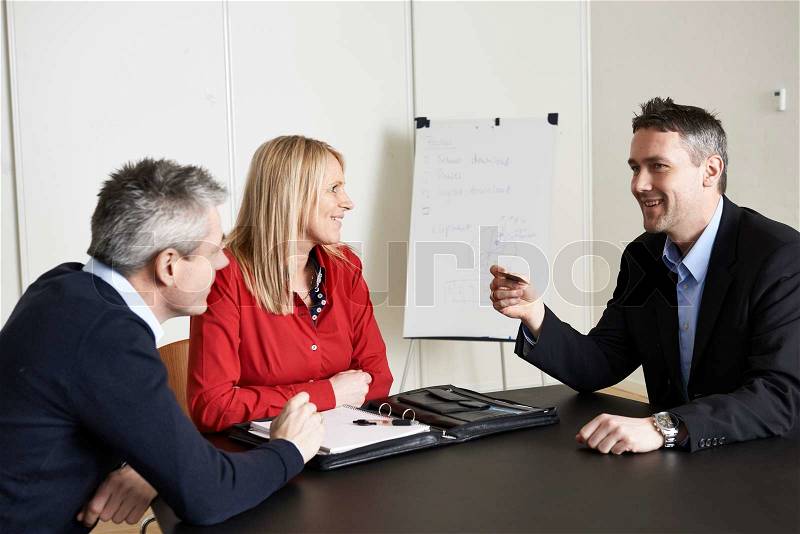 Couple receiving a business card, stock photo