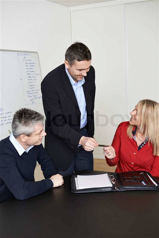 Couple receiving a business card, stock photo