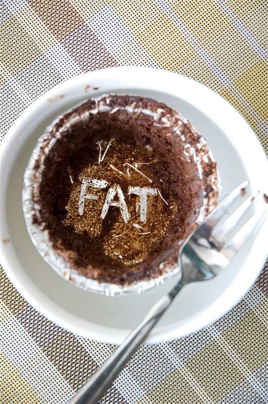 Text fat on empty cup of chocolate cupcake, stock photo