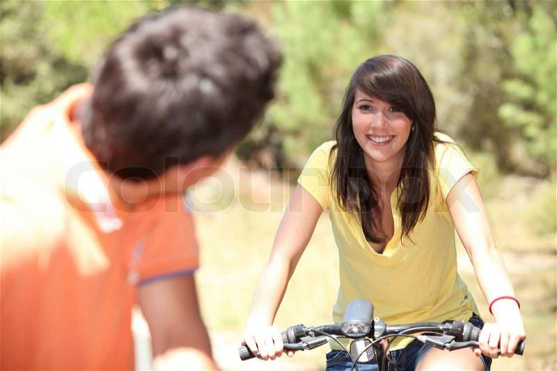 Smiling couple on a bicycle, stock photo