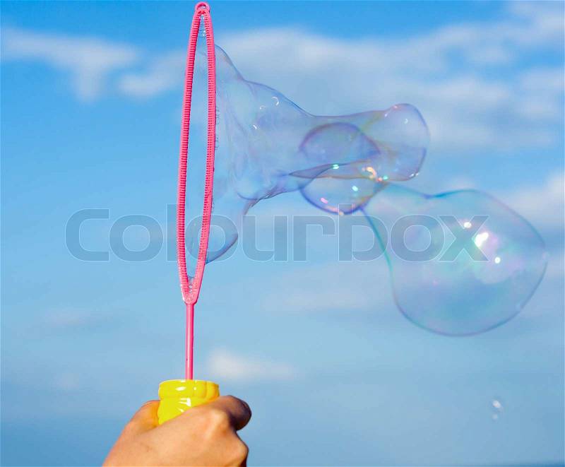 Colorful Soap Bubbles Against Blue Sky Background, stock photo