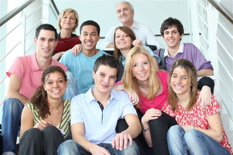 Group of young people sitting on stairs, stock photo