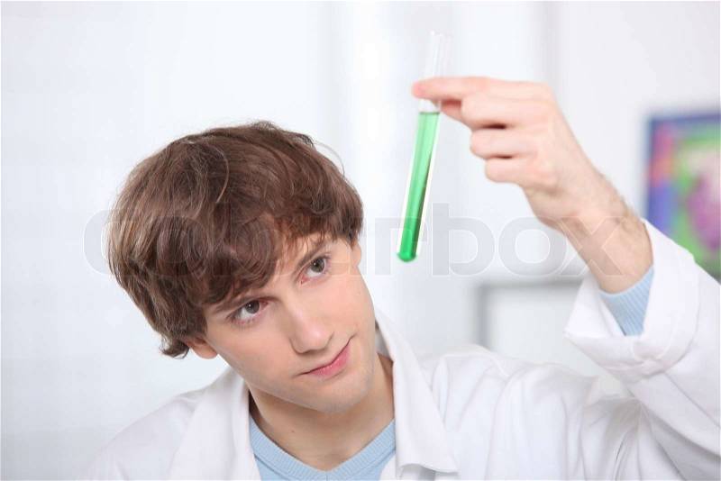 Male teenager in science laboratory, stock photo