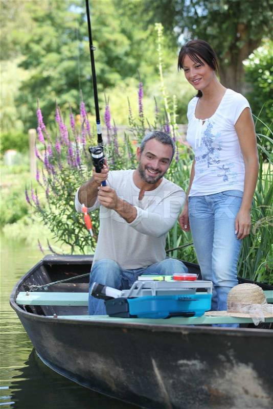 Couple in a fishing boat, stock photo