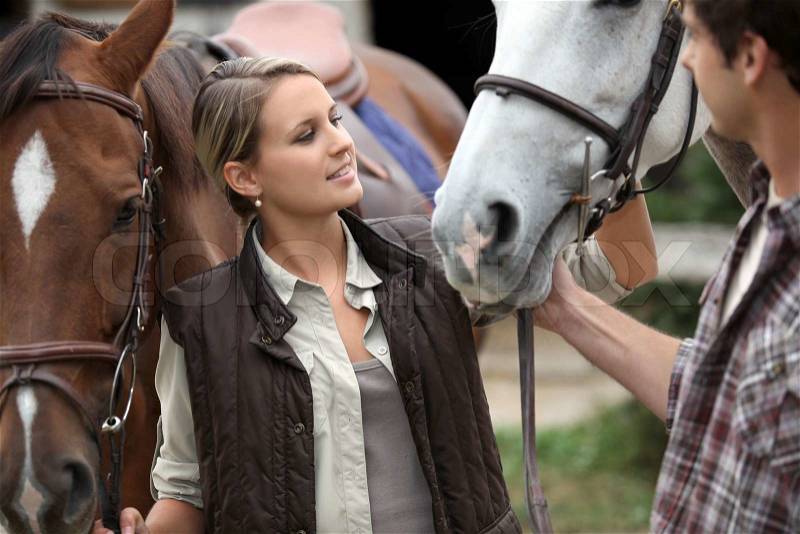 Portrait of a young woman with horses, stock photo