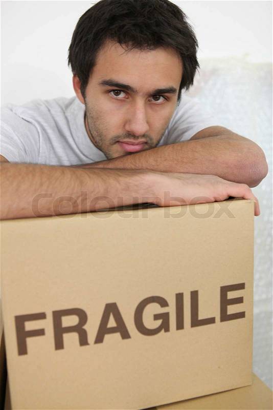A tired man on moving day, stock photo