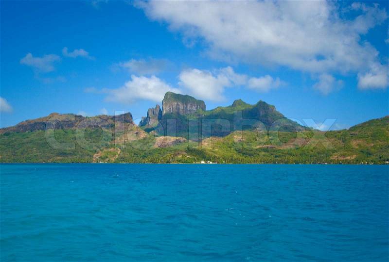 Clear blue lagoon with a view on the tropical island of Bora Bora, near Tahiti, in French Polynesia, stock photo