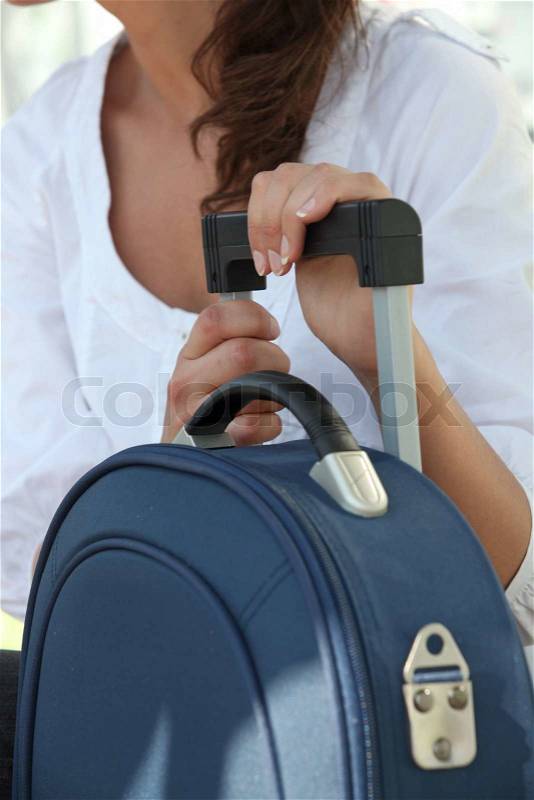 Young woman with luggage, stock photo