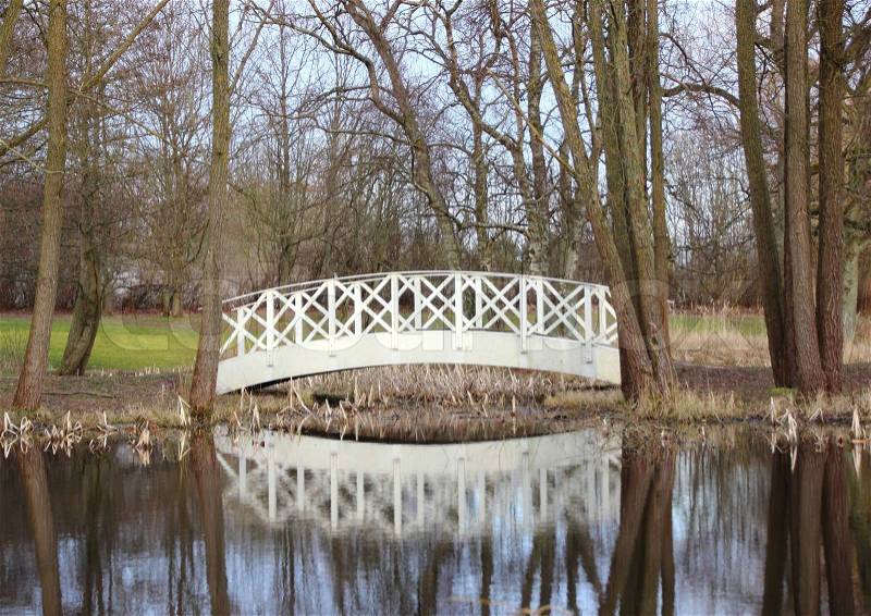 White bridge at small pond in park, stock photo