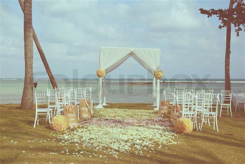 Vintage wedding arch set up on beach ,filtered image, stock photo