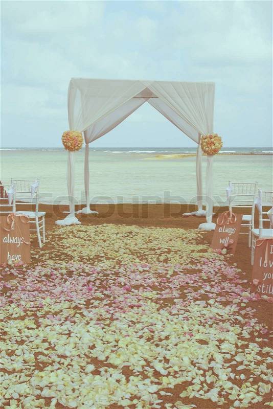 Vintage wedding arch set up on beach ,filtered image, stock photo