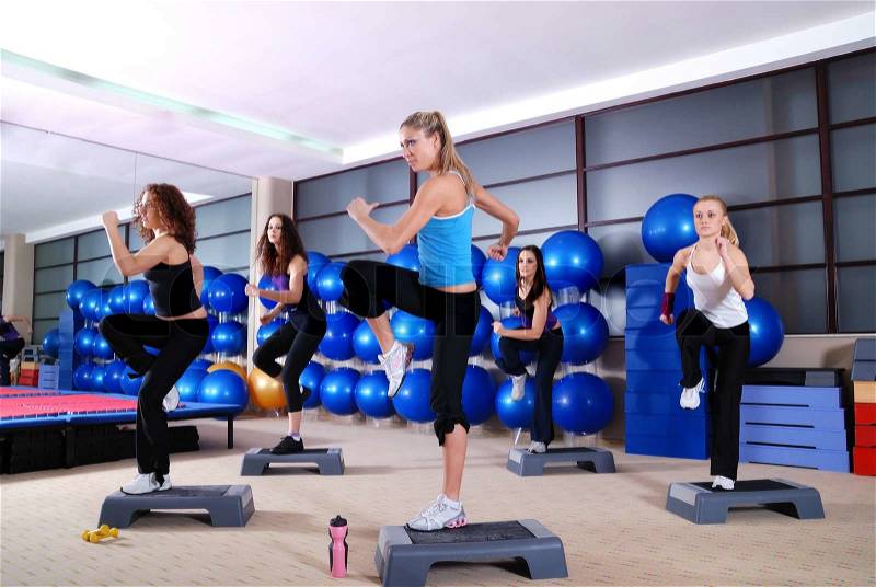 Group of girls stepping in a fitness club, stock photo