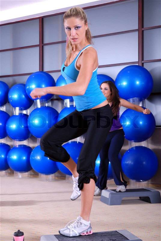 Woman stepping in a fitness center, stock photo