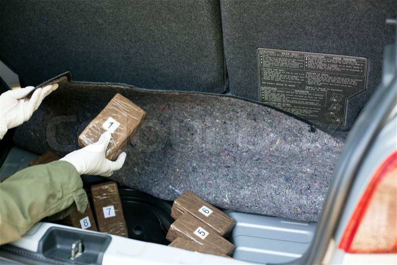 Illegal drug trade in the trunk of a car, stock photo