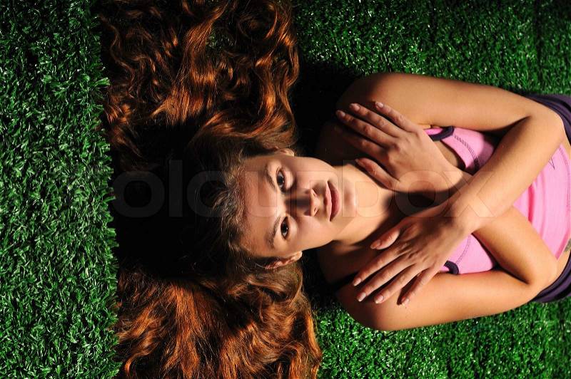 Young woman relax on green stairs with speakers around , stock photo