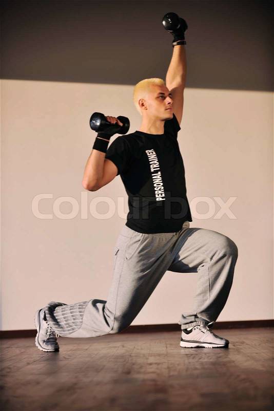 Man fitness personal trainer in sport club, stock photo