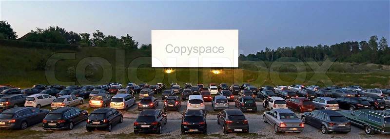 Drive-in theater with copyspace on movie screen, stock photo