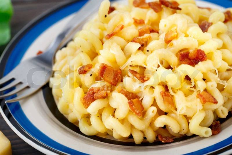 Delicious mac and cheese with bacon in a bowl, stock photo