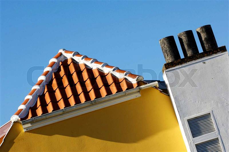 Slanting image of a yellow building with tile roof, stock photo