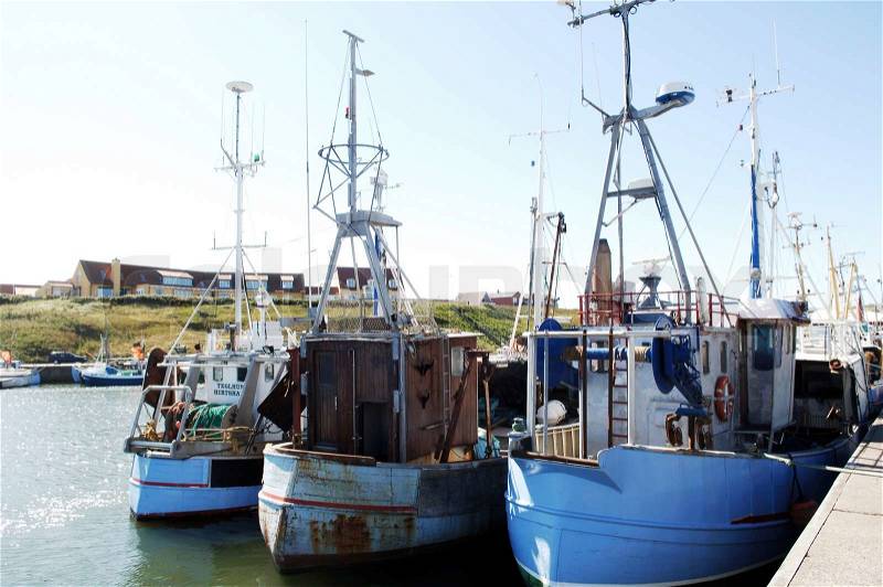 Fishing boats docked on a marina, stock photo