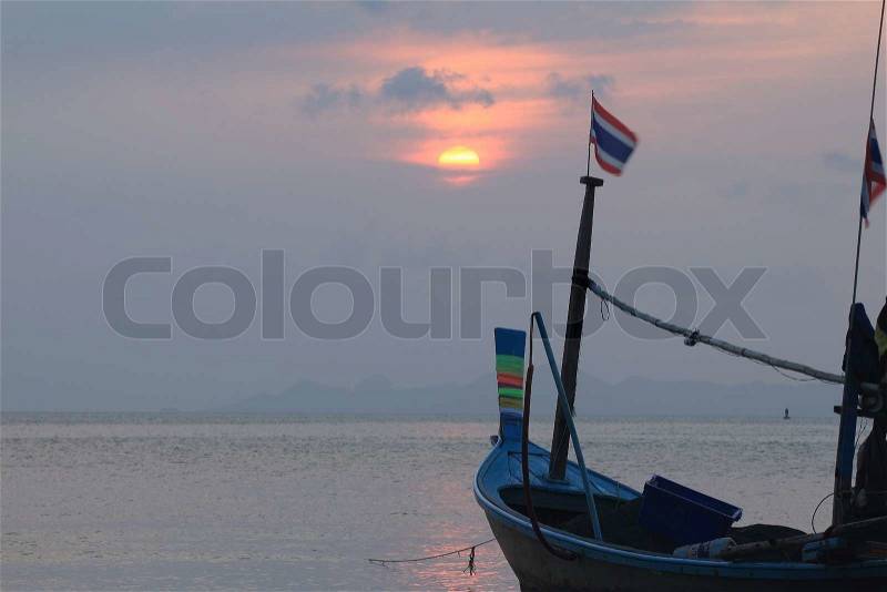 Stunning red sunset over sea and sky with fishing boat ,Samui Thailand, stock photo