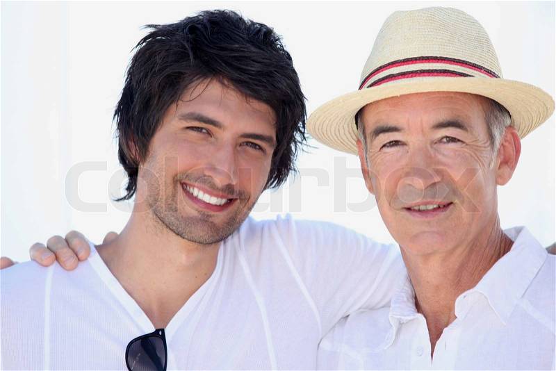 Two men with their arms around each other\'s shoulders, stock photo