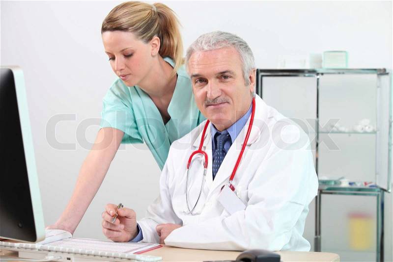 Doctor and nurse at a computer, stock photo