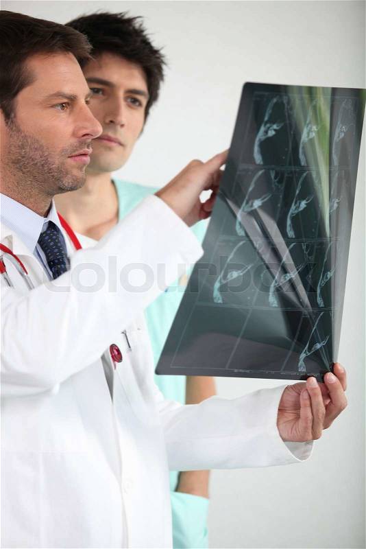 Two doctors looking at x-ray image, stock photo