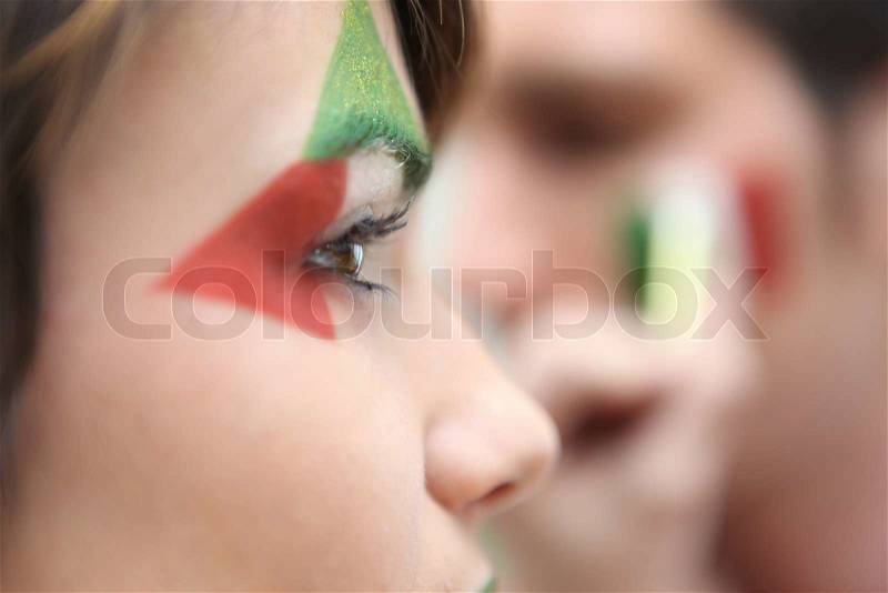 Beautiful italian brunette supporting national soccer team, stock photo
