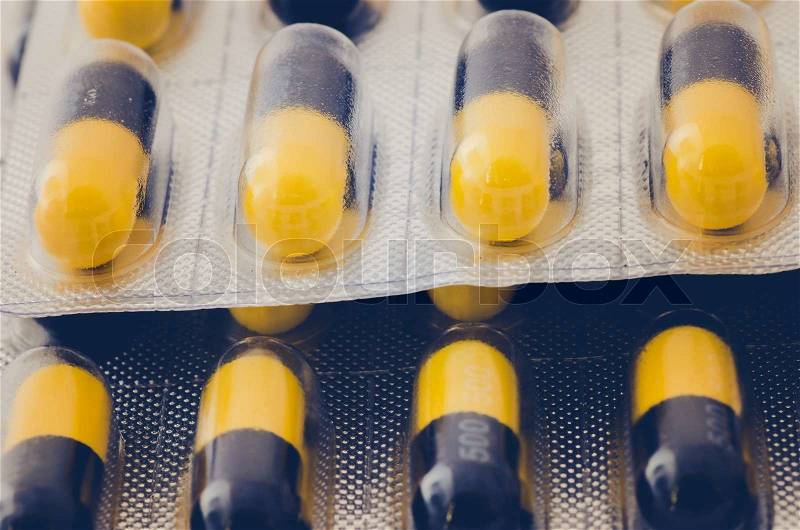 Black and yellow capsule pack madicine heath concept, stock photo