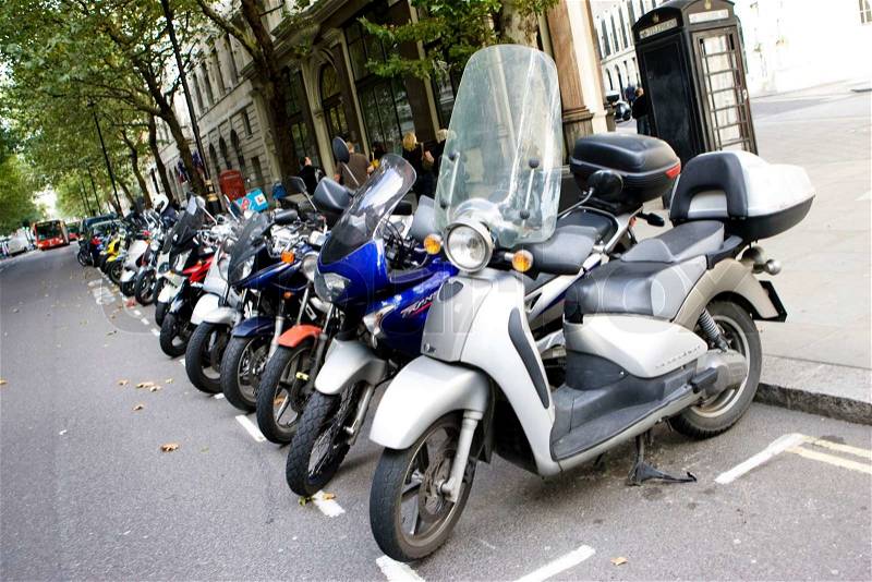 Row of motorbikes parked on a street in England, stock photo