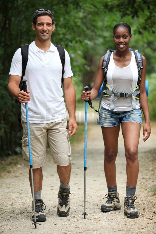 Couple hiking through countryside, stock photo