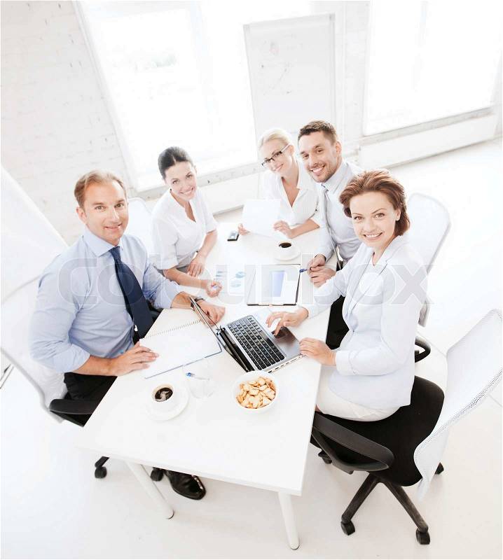Business concept - friendly business team having meeting in office, stock photo